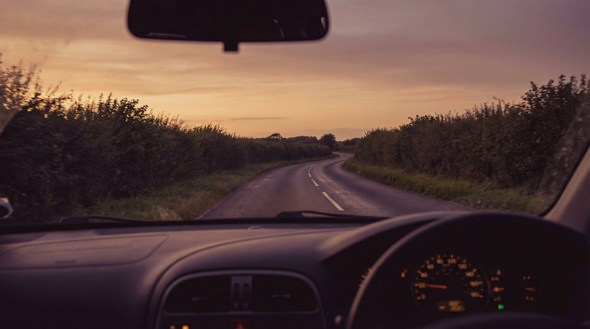 Evening country road at dusk through car windscreen