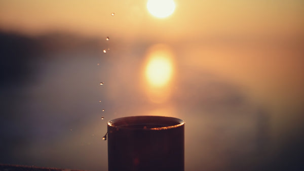 Coffee cup at golden sunrise