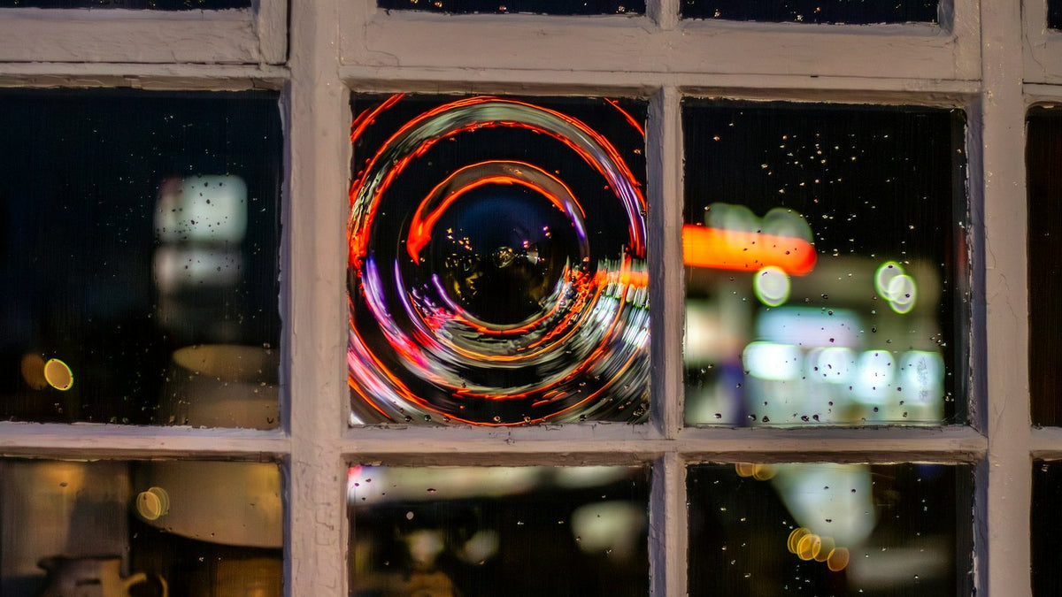 Fireworks seen through a window at night