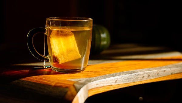 Cup of herbal tea on a cozy table setting