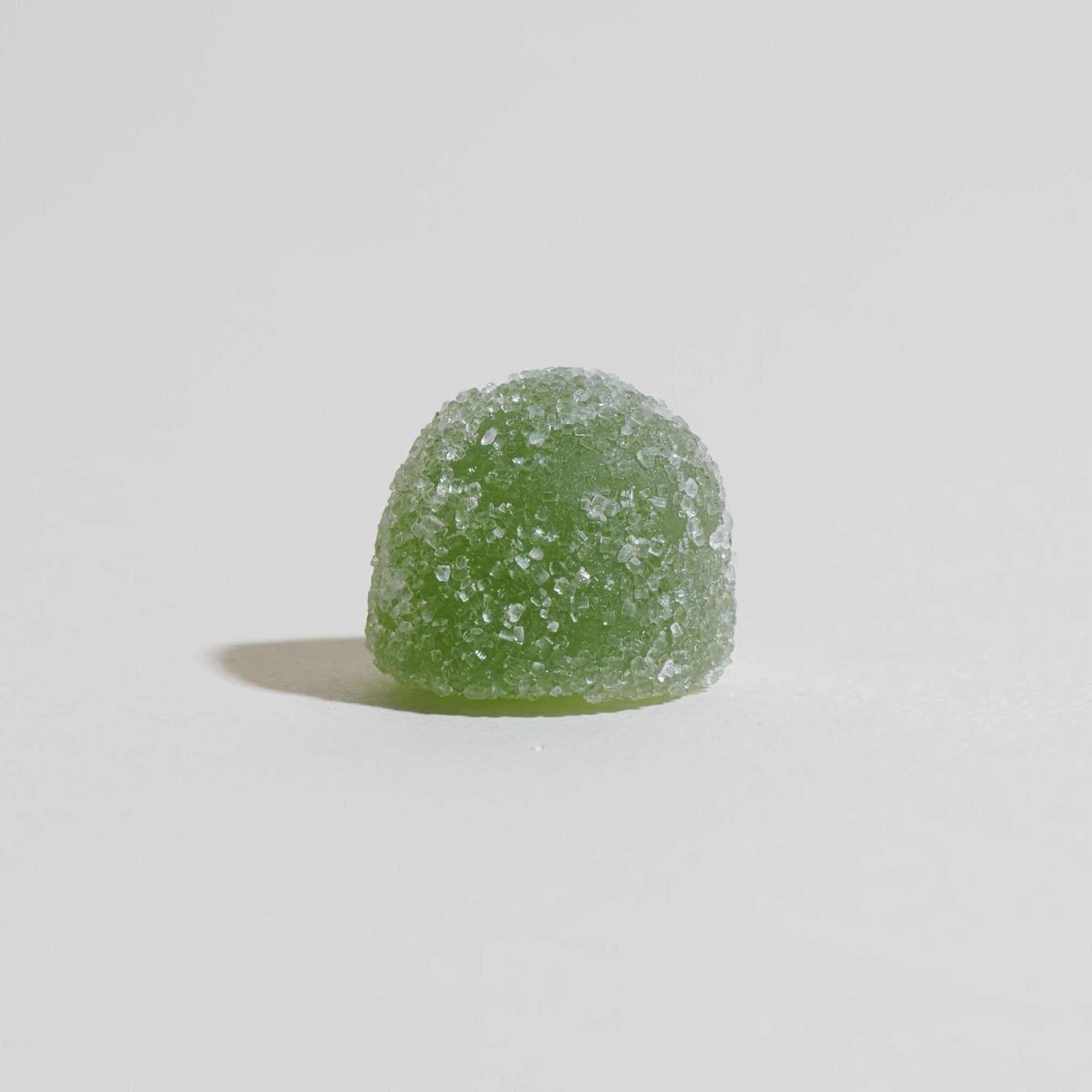 Unspun Broad Spectrum CBD Gummies - A single green gummy 