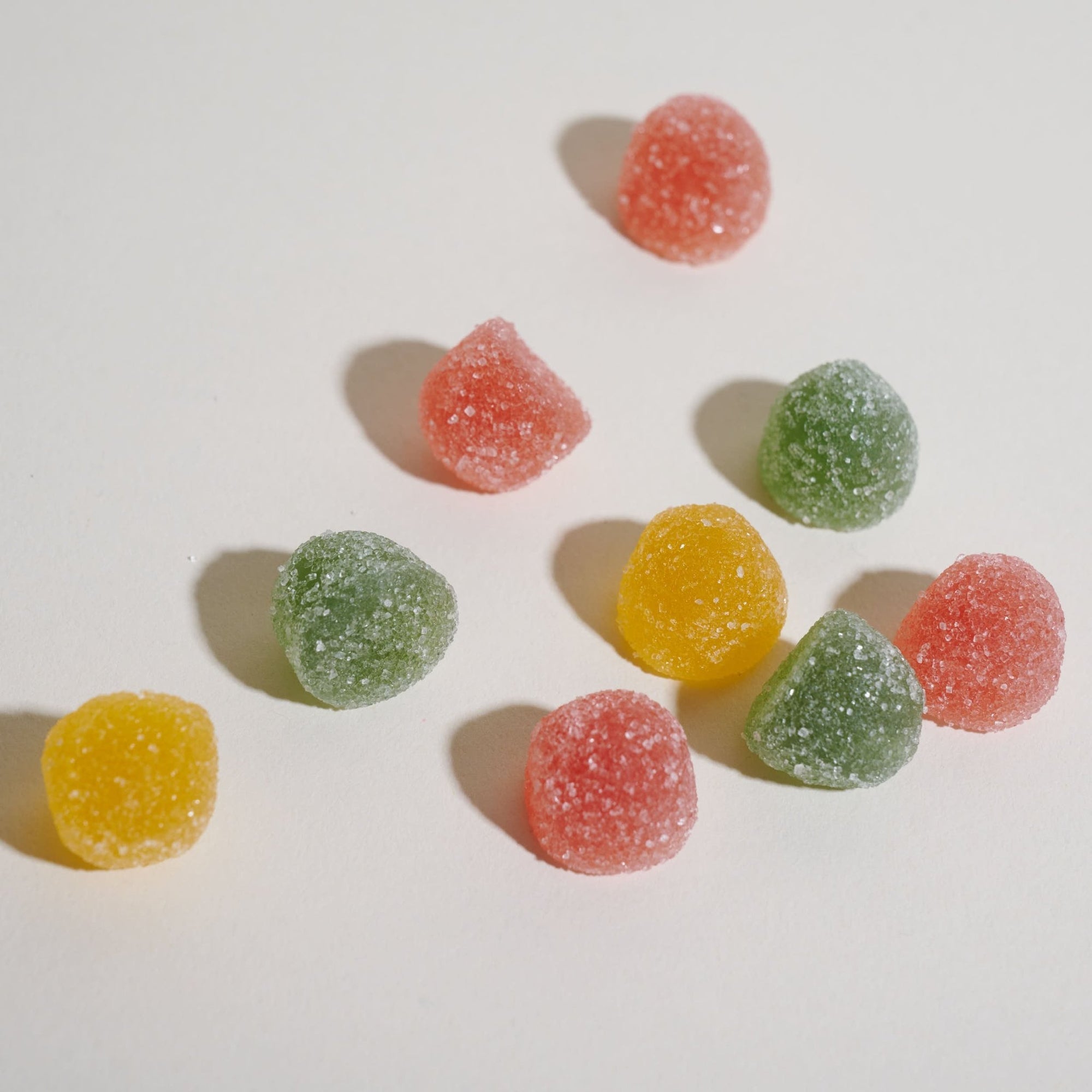 Unspun Broad Spectrum CBD Gummies - Gummies artfully arranged on a light background 